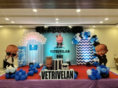 Boss Baby themed first birthday stage with blue and white balloons at VJK Mahal, Pallavaram Chennai