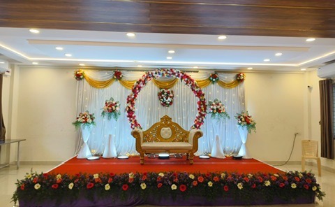 Reception stage with rose arch and flower border at VJK Mahal mini hall, Pallavaram Chennai