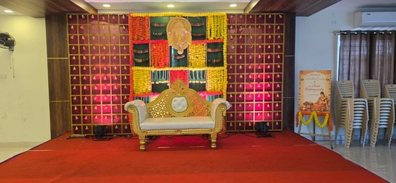 Valaikappu stage with marigold garlands and Ganesha backdrop at VJK Mahal, Pallavaram Chennai