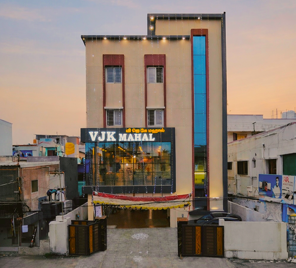 VJK Mahal mini hall exterior at dusk, Pallavaram Chennai — illuminated signage and festive lighting